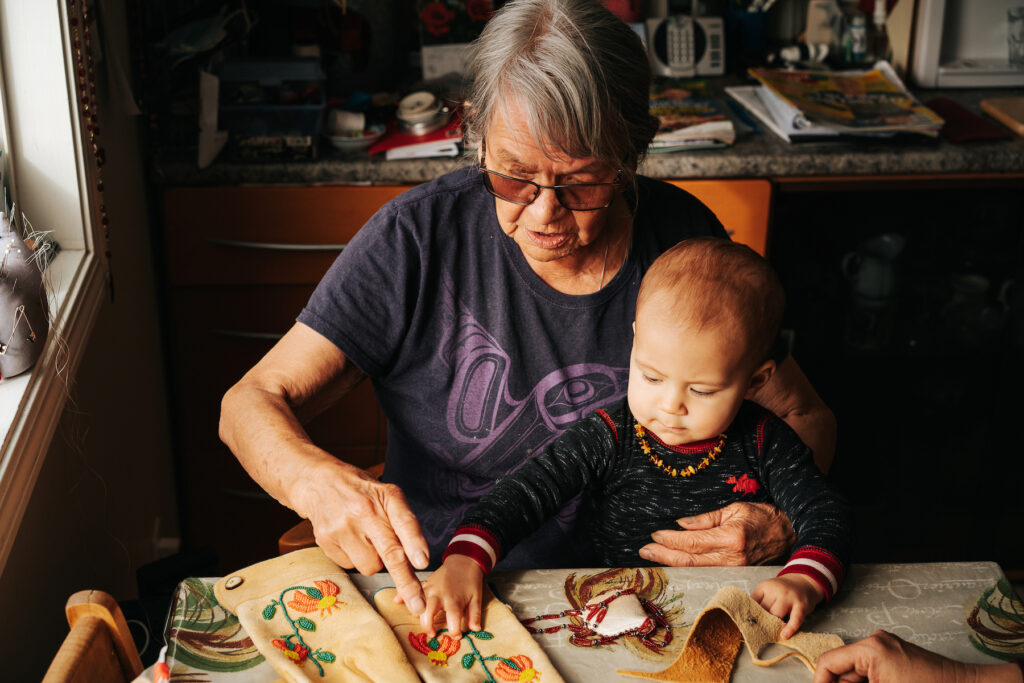Photo of elder and baby provided by First Peoples Cultural Council